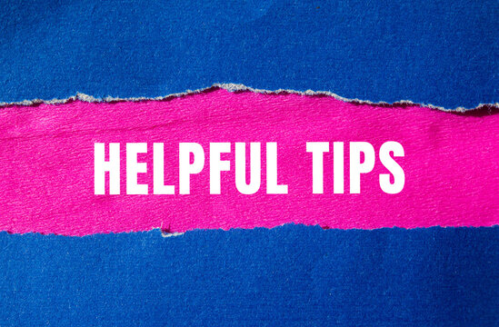 Helpful tips message written on ripped torn paper background. Conceptual Helpful tips symbol. Copy space.