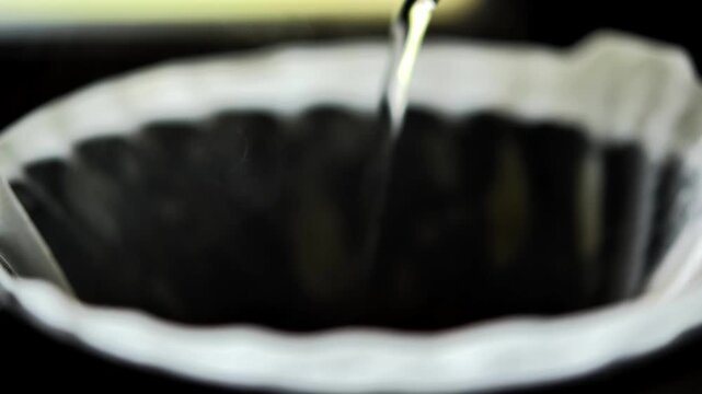 Pouring Hot Water Over Ground Coffee for Drip Brewing	