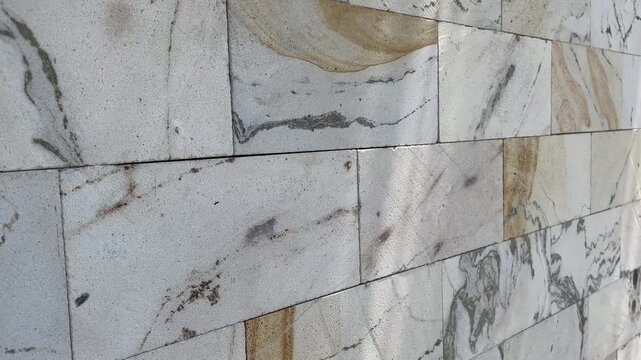 Elegant stone block wall architecture footage with dynamic light reflection