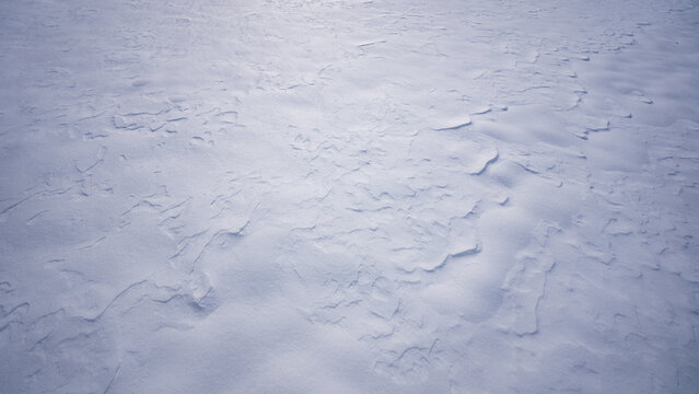 White frozen background with snow. Winter surface with snow pattern. Frozen frost texture with snow sparkles. Snowflakes on white icy background. Winter backdrop with snow.