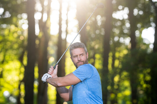 Golfer swing. Golfer powerful swing. Man in Golf club. Outdoor golf practice. Golfer completes backswing. Man practice Golf outdoors. Golf club concept.