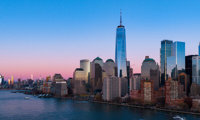 Naklejka premium New York City panorama in daylight. New York skyline with Freedom Tower. New York harbor and waterfront. NYC skyscrapers reflect below.