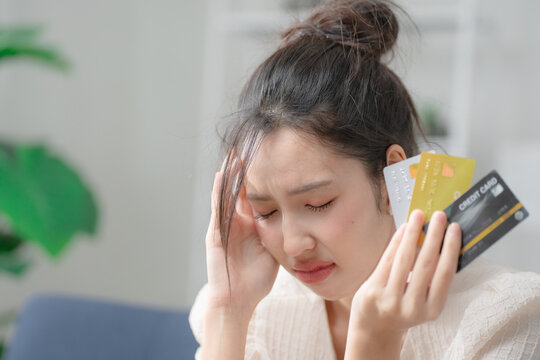 Credit card debt concept. Stressed woman holding multiple credit cards, facing financial problems and debt management. Credit, debt, finance, budgeting, payment