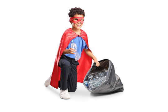 Superhero boy collecting plastic bottles into a garbage bag for recycling