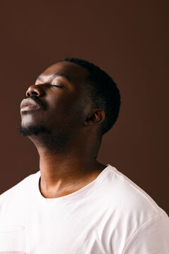 Calm Portrait of Man With Eyes Closed in White Shirt