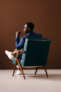 Thoughtful Businessman Sitting in Vintage Armchair Portrait
