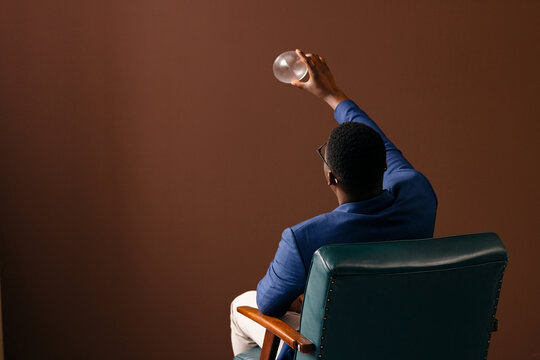 Businessman Holding Glass Sphere While Contemplating