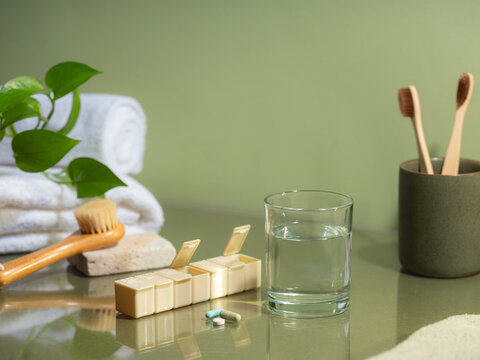Daily health routine with pills, water, and toothbrushes
