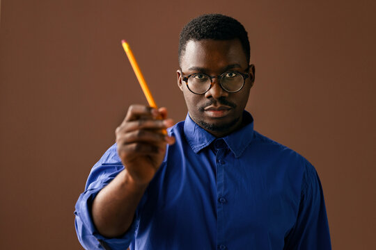 Man Holding Pencil Pointing Forward