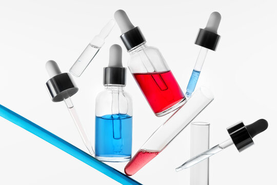 Skincare Bottles and Laboratory Glassware in Balanced Composition