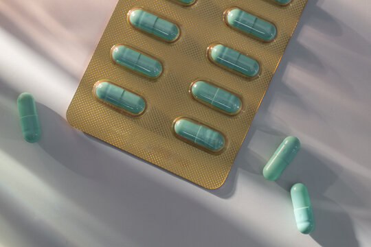 Close-up of turquoise capsules in a blister pack