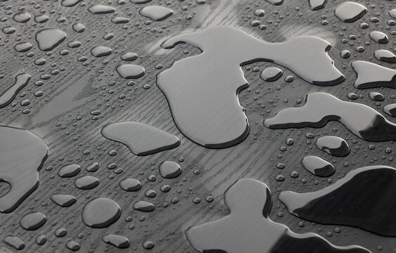 water puddles and raindrops on a bistro table after heavy summer rain