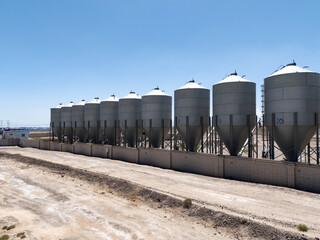Industrial metal silos under blue sky © zhu difeng
