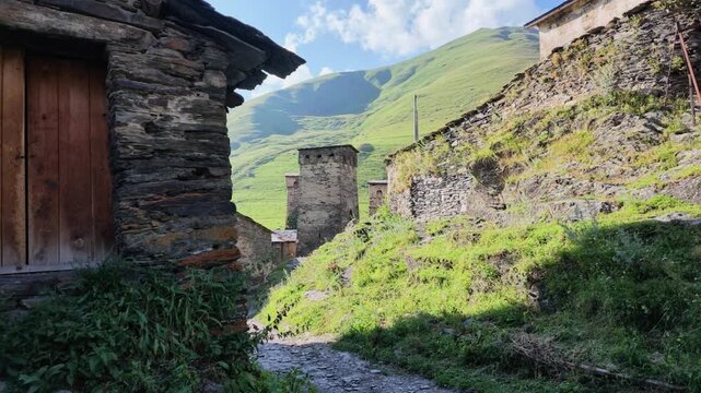 Ancient stone houses and defensive Svan towers in the historic mountain village of Chazhashi in Ushguli, Svaneti region, Georgia, showing traditional Caucasian architecture on a sunny summer day