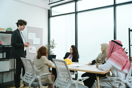 Business teamwork meeting in a modern office where diverse professionals review reports and discuss strategy, collaboration, leadership, planning, productivity, corporate analysis and growth.