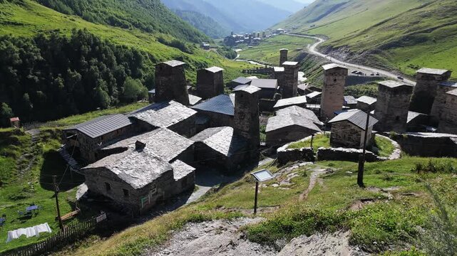 Chazhashi village in Ushguli community, Georgia, featuring svan stone towers, medieval defensive structures, and green mountain landscape, historical heritage, rural tourism