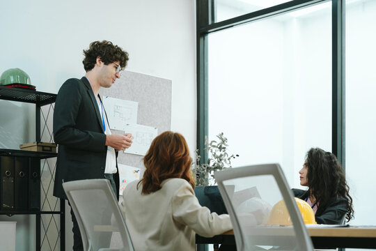 Business teamwork meeting in a modern office where diverse professionals review reports and discuss strategy, collaboration, leadership, planning, productivity, corporate analysis and growth.