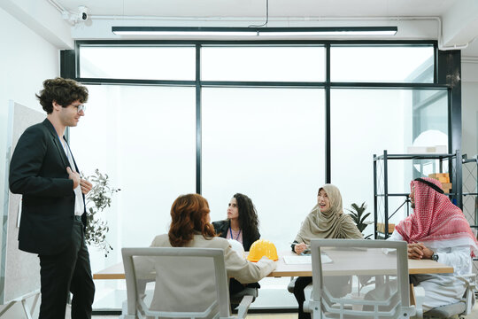 Business teamwork meeting in a modern office where diverse professionals review reports and discuss strategy, collaboration, leadership, planning, productivity, corporate analysis and growth.
