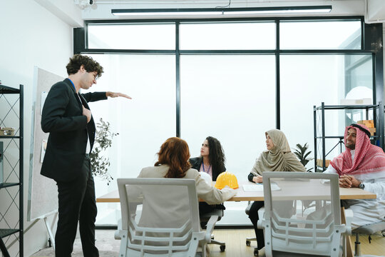 Business teamwork meeting in a modern office where diverse professionals review reports and discuss strategy, collaboration, leadership, planning, productivity, corporate analysis and growth.