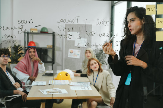 Business teamwork meeting in a modern office where diverse professionals review reports and discuss strategy, collaboration, leadership, planning, productivity, corporate analysis and growth.