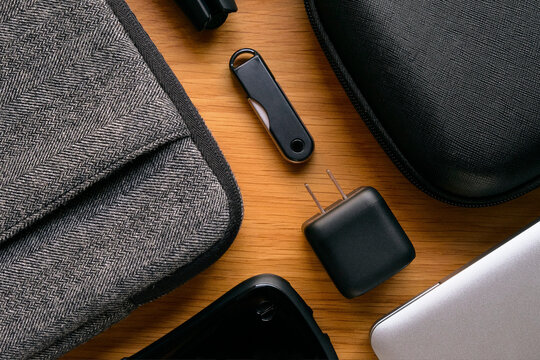 USB Charger with Gadgets on Wooden Table