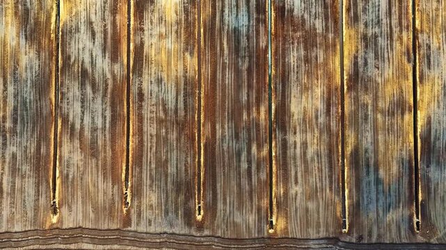 Aerial view of weathered wooden texture with vertical grooves and horizontal patterns in Jelgava, Latvia.