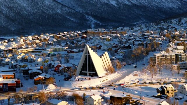 Side lit telephoto drone view of iconic Arctic Cathedral in winter in Tromso