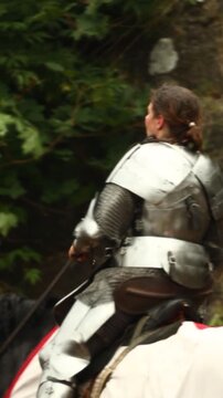 Russia, Vyborg, August 8, 2020 A knight in armor riding on the back of a white horse
