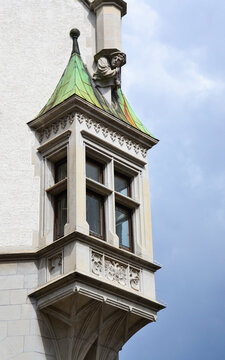 Gothic Stone Oriel Window with Sculpted Figure and Copper Roof Accent