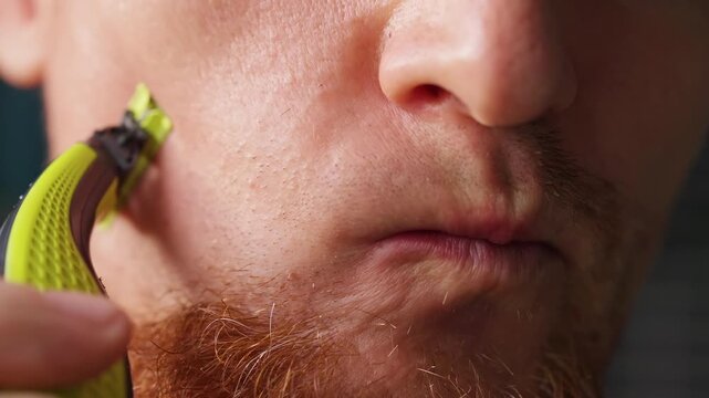 Man Trims Mustache and Beard Stubble With an Electric Razor in Extreme Close Up, Personal Grooming and Self Care