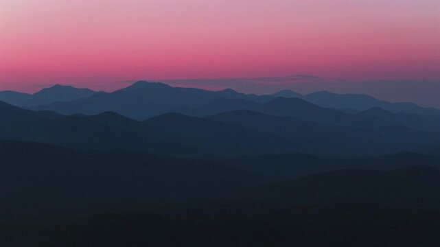 Vibrant pink blue hour sunset Adirondack Mountain Upstate New York above Schroon Lake aerial drone view Adirondack High Peaks layers New York State Mount Severance Pharaoh Lake Wilderness circle right