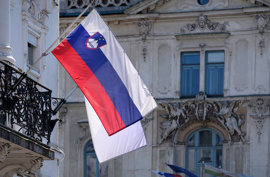 Slovenian national flag hanging from a building in Ljubljana
