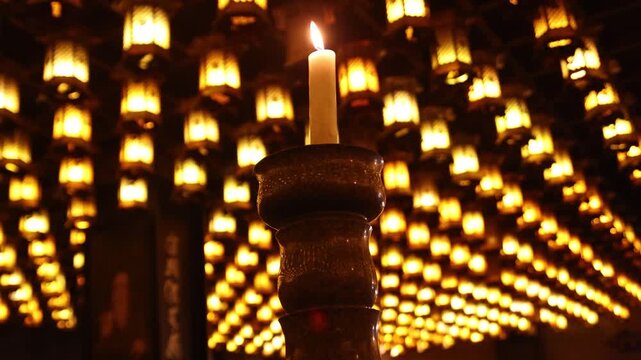 Traditional paper lanterns glowing brightly inside a historic temple during the Kangen Sai Festival on Miyajima Island, Hiroshima, Japan