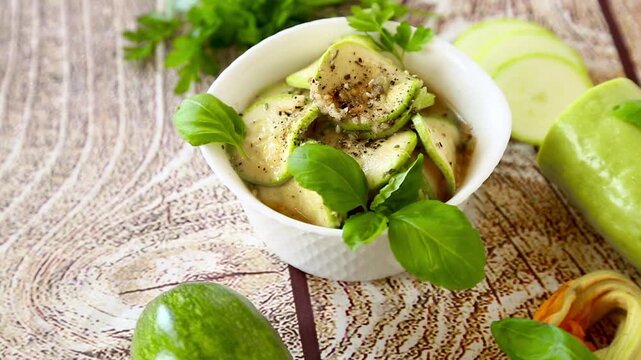 Spicy zucchini with garlic and basil on textured wood background