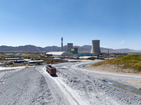 large power plant with cooling towers in gobi desert landscape