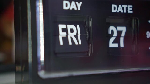 retro flip alarm clock changing date, dark bedroom scene, time passage and calendar concept.