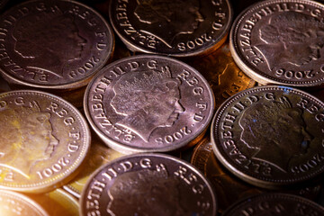 British pennies and two pence featuring Queen Elizabeth II profile portrait. British copper coins. Great Britain national currency. © Sergii