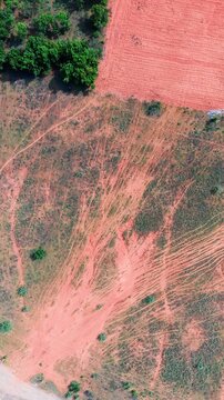In Hoa Thang, Lam Dong, the camera shows a view of fields with interesting patterns on the soil. These lines create visual shapes across the landscape.