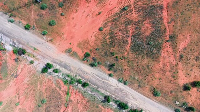 The landscape of Hoa Thang in Lam Dong province. It features roads winding through open fields and the textures of the land. You can see the natural colours and patterns.
