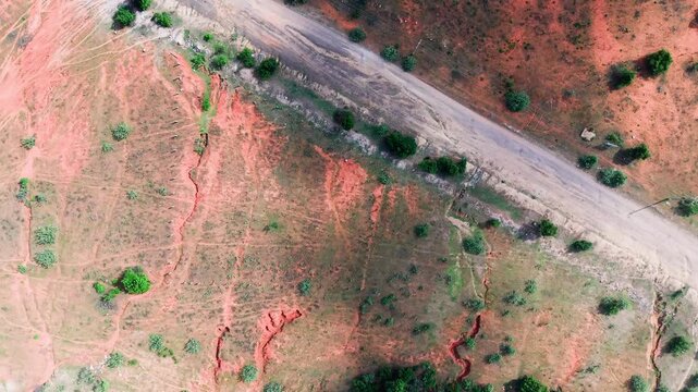 Aerial views show the red earth and green patches in Hoa Thang, Lam Dong. This area features roads and flowing lines that highlight the land's shape at different angles.