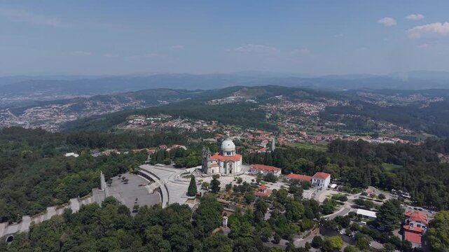 Aerial - Sameiro Sanctuary surrounded by pine forest with Braga and distant hills beyond