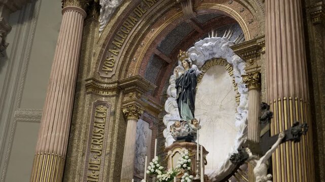 Statue of the crowned Virgin Mary on carved clouds above the altar inside Sameiro Sanctuary Braga