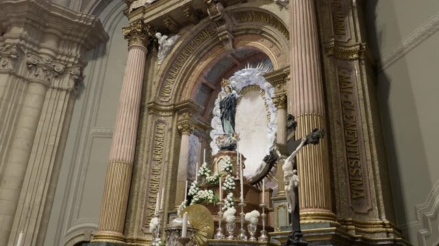 Gilded high altar of Sameiro Sanctuary in Braga with the Virgin Mary statue candles and flowers