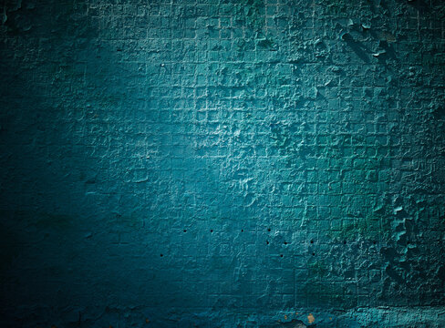 Dramatic light on vintage aqua blue wall texture