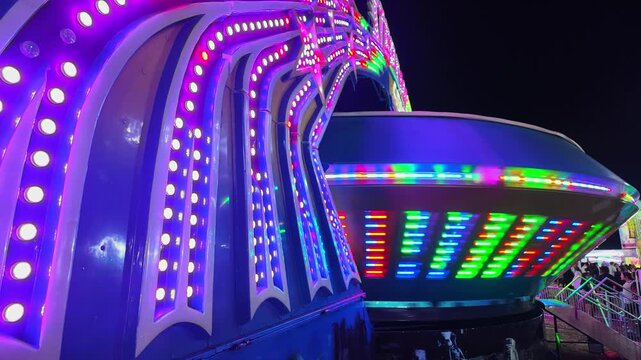 Flashing colorful lights on a carnival ride at the Uncle Sam Jam summer festival in Woodhaven, Michigan