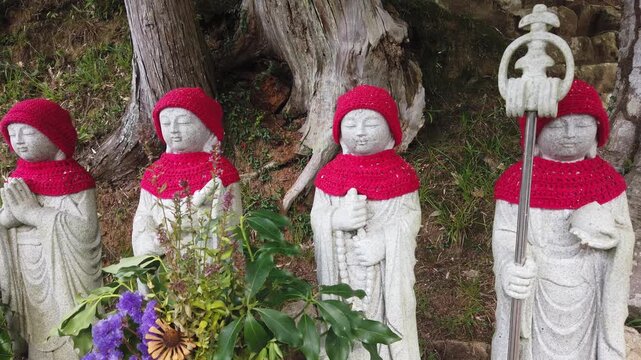 Close Up Panning Buddhist Stone Jizo Bodhisattva Statues Temple Shrine Japan