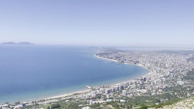 Elevated panoramic view over Vlor&euml;, Albania, showing the sweeping coastline, urban beachfront, turquoise Adriatic and Ionian waters and the city stretching around the Bay of Vlor&euml;