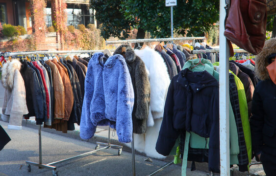 Second hand winter clothes and vintage coats on display at a street flea market stall