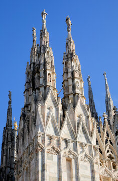Gothic spires and marble statues on the roof of Milan Cathedral Duomo di Milano in Italy