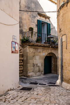 Picturesque street in the historic center of Otranto, with traditional buildings and a relaxed atmosphere reflecting the slow pace of life, Otranto, Salento, Puglia, Italy.